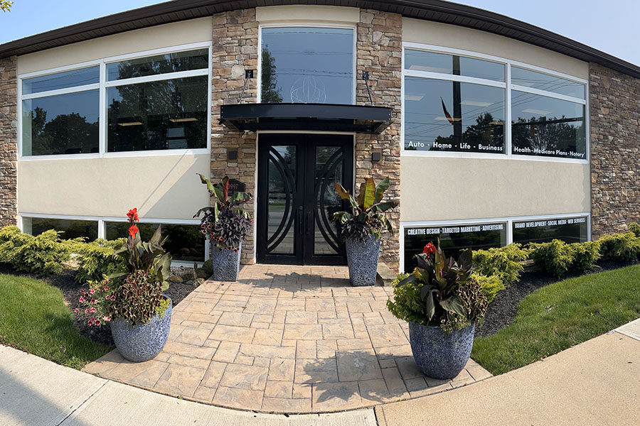 We Are Independent - Front Entrance of the Andrako Insurance Consultants Office Building with Potted Plants on a Stone Walkway